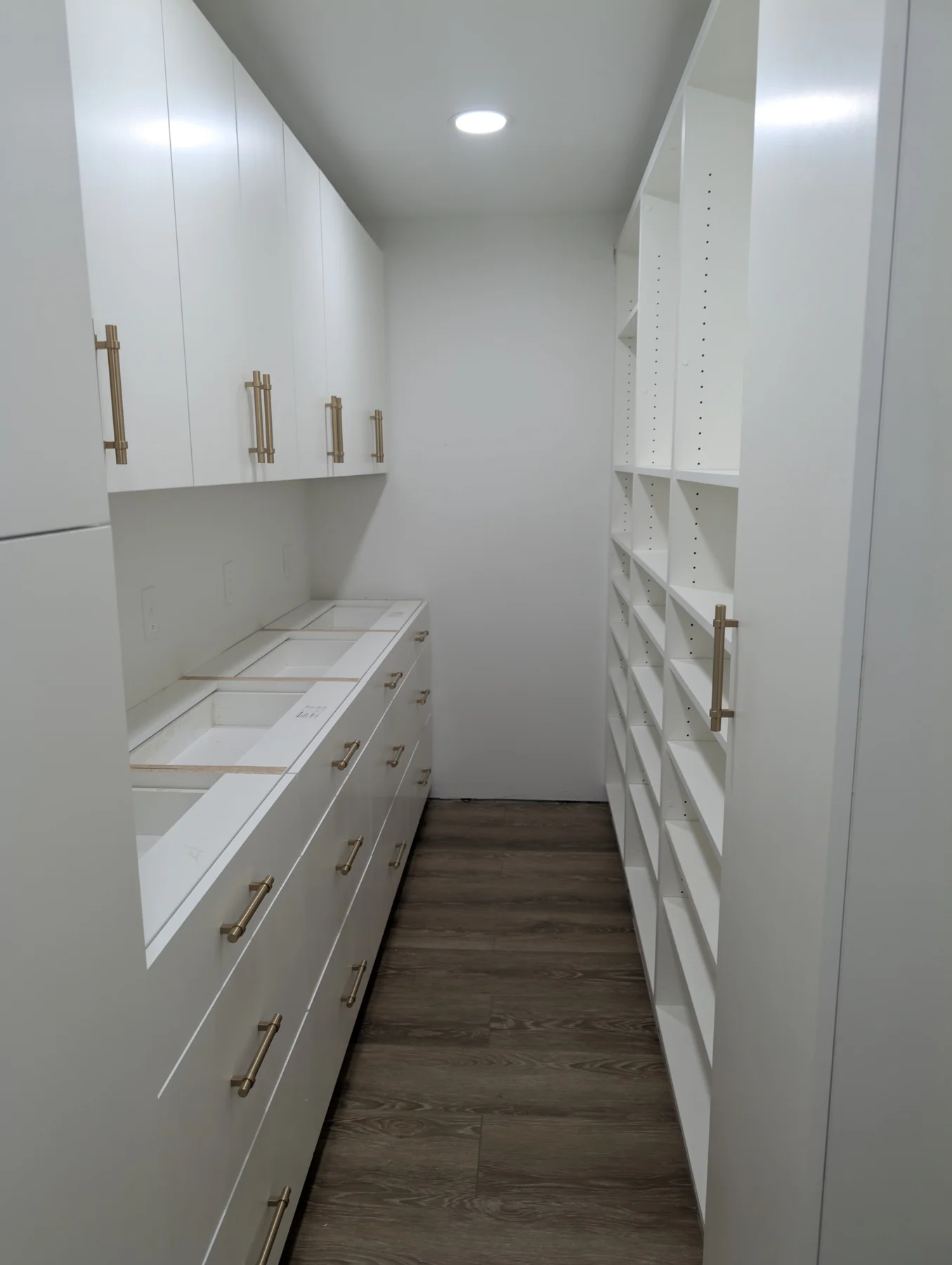 White pantry cabinetry with drawers and open shelving